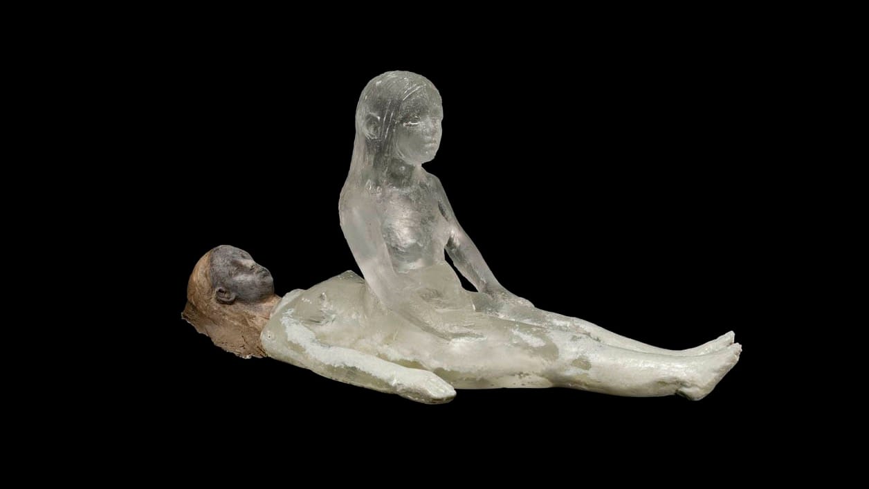 A sculpture by Christina Bothwell. A sleeping woman lies on her back, while her spirit sits up, awake.